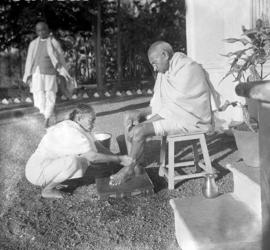 Kasturba Gandhi washing Gandhi's feet