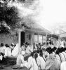 Gandhi and Kasturba Gandhi speaking to coresidents